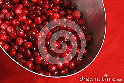 Bowl of cranberries on a red background Stock Photo