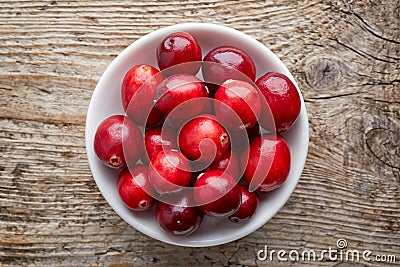 Bowl of cranberries on wooden table, from above Stock Photo