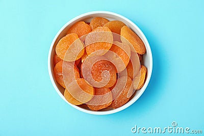 Bowl with dried apricots on color background, top view. Stock Photo