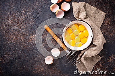 Bowl with eggs yolks and whisk Stock Photo