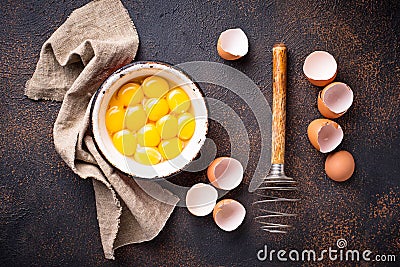 Bowl with eggs yolks and whisk Stock Photo