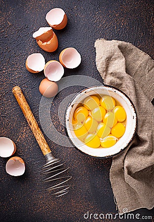 Bowl with eggs yolks and whisk Stock Photo