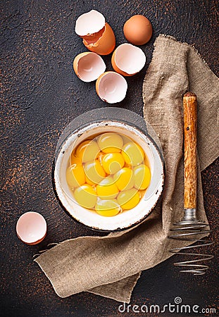 Bowl with eggs yolks and whisk Stock Photo