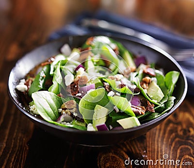 Bowl of fresh avocado spinach salad Stock Photo