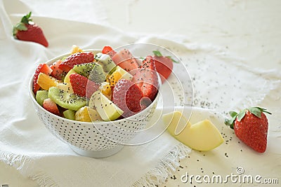 Bowl of fresh fruit salad, kiwi, apples, oranges Stock Photo
