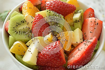 Bowl of fresh fruit salad, kiwi, apples, oranges Stock Photo