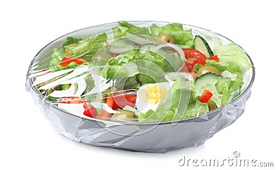 Bowl of fresh salad wrapped with transparent plastic stretch film isolated on white Stock Photo