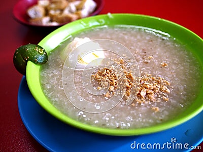 Bowl of freshly cooked rice porridge with egg and pork innards Stock Photo