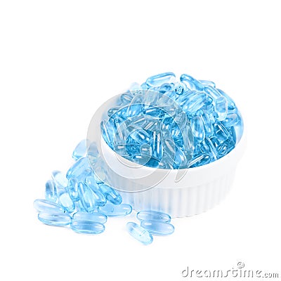Bowl full of blue softgel pills Stock Photo