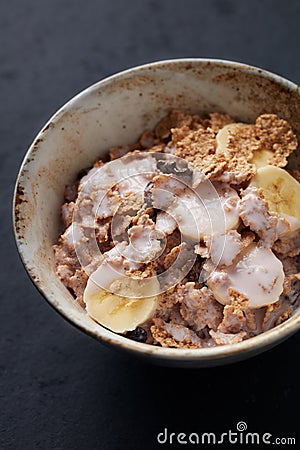 Bowl of granola with yogurt and banana. Concept for a tasty and healthy meal. Stock Photo
