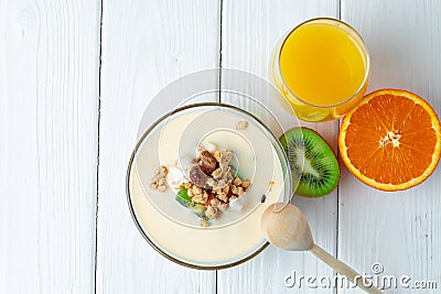 Bowl of granola with youghurt and sliced fruits Stock Photo