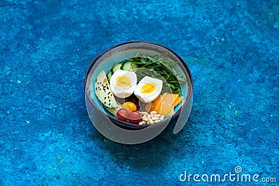 Bowl Healhty salad with avocado, egg and fresh vegetables. Stock Photo