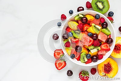 Bowl of healthy fresh fruit salad on white marble background. healthy food. top view Stock Photo