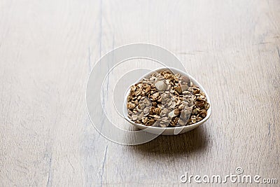 Bowl of healthy granola on wooden background Stock Photo