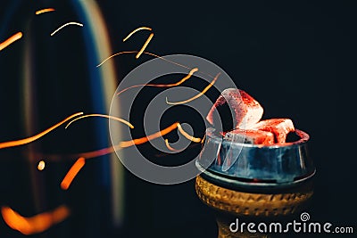 Bowl of hookah with hot coals and red sparks flying for tobacco and Smoking and traditional Asian holiday Stock Photo