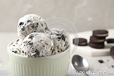 Bowl with ice cream and crumbled chocolate cookies on table. Space for text Stock Photo