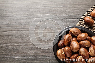 Bowl with jackfruit seeds on wooden table, flat lay. Space for text Stock Photo