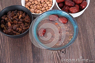 A bowl of Laba porridge and some dried fruit ingredients Stock Photo