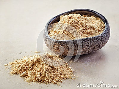 Bowl of maca powder Stock Photo