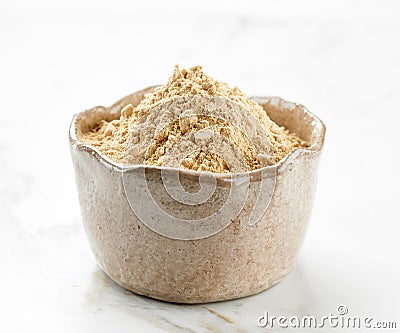 Bowl of maca powder Stock Photo