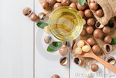 Bowl of macadamia nut oil and macadamia nuts Stock Photo