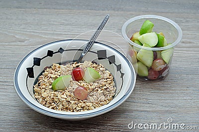 A bowl of muesli with pieces of apple and grapes Stock Photo