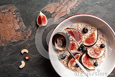 Bowl with oatmeal, blueberries, figs, chia seeds, and nuts, Healthy breakfast Gluten, lactose free, Fitness food Stock Photo