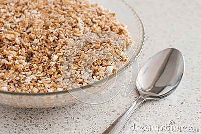 Bowl of oatmeal and a spoon Stock Photo