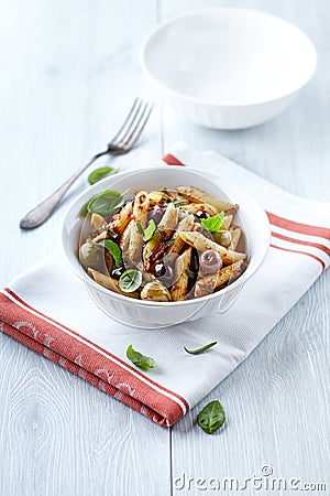 Penne with dried tomato pesto, olives and herbs Stock Photo