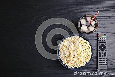 Bowl with popcorn, glass of iced cola and TV remote Stock Photo