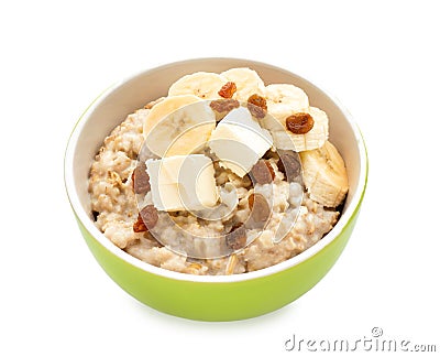 Bowl with prepared oatmeal, raisins and banana on white background Stock Photo