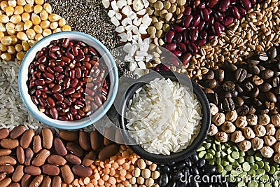 Bowl with raw white rices and beans on various seeds grain Stock Photo