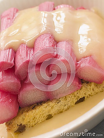 Bowl of Rhubarb and Custard with Saffron Cake Stock Photo