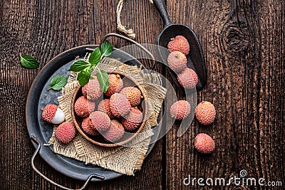 Bowl of ripe lichee fruit (Litchi chinensis) on wooden background Stock Photo