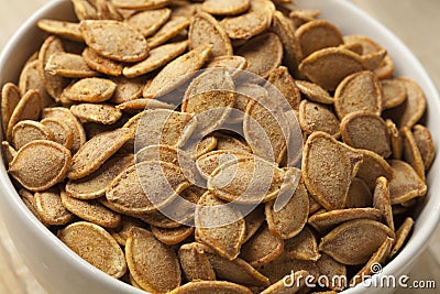 Bowl with roasted pumpkin seeds Stock Photo