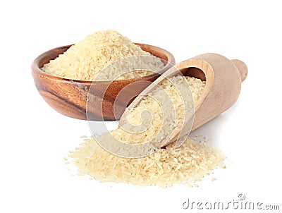 Bowl and scoop with uncooked parboiled rice Stock Photo