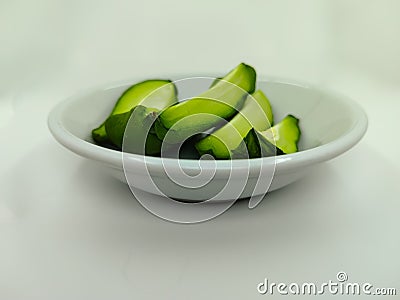 a bowl of several pieces of boiled chayote on a white background Stock Photo