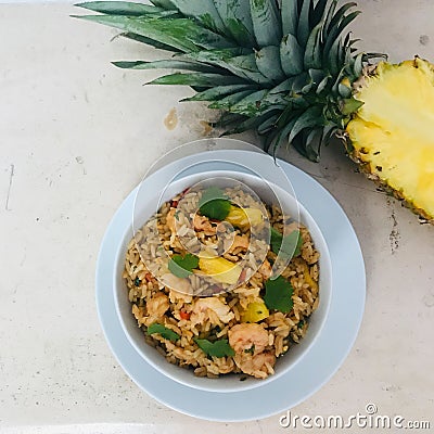 A bowl of shrimp and pineapple fried rice Stock Photo