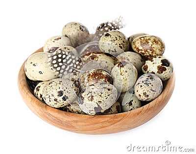 Bowl with speckled quail eggs and feathers isolated on white Stock Photo