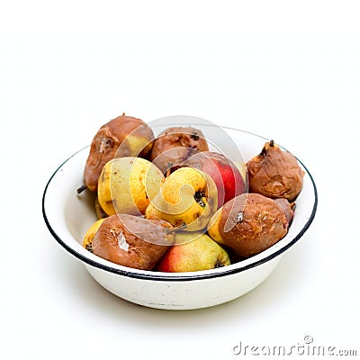 Bowl with spoilt pear isolated on white Stock Photo