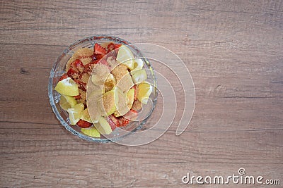 A bowl of strawberries, a lemon and brown sugar. Stock Photo