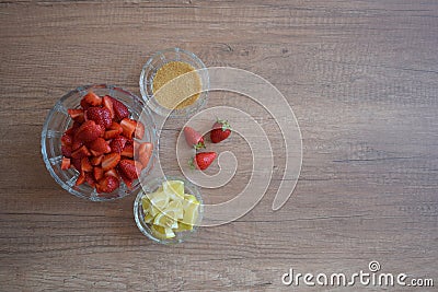 A bowl of strawberries, a lemon and brown sugar. Stock Photo