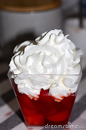 Bowl of strawberries with sugar and cream. Bokeh effect Stock Photo