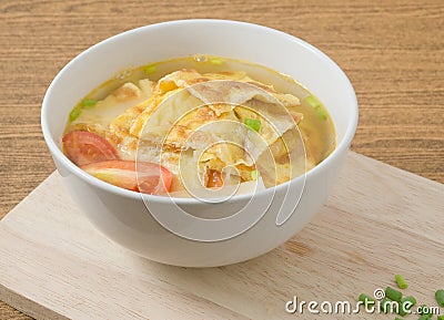 Bowl of Thai Omelet Soup with Tomatoes and Scallion Stock Photo
