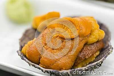 A bowl of uni sashimi on ice Stock Photo