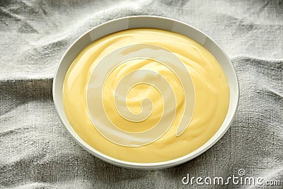 Bowl of vanilla custard on rustic background Stock Photo