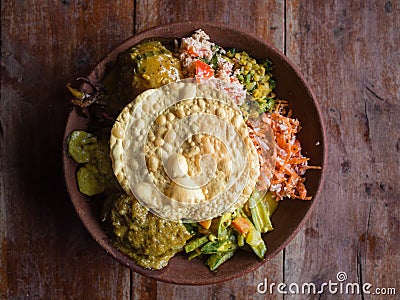 Bowl of variety of traditional vegan Sri Lankan food with different curries, papadum, rice, sambol, dal and vegetables Stock Photo