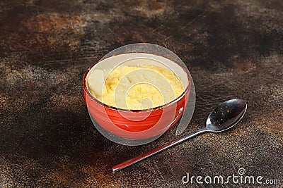 Bowl of wheat porridge and spoon, tasty breakfast Stock Photo