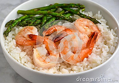 sauteed asparagus and shrim on white rice Stock Photo