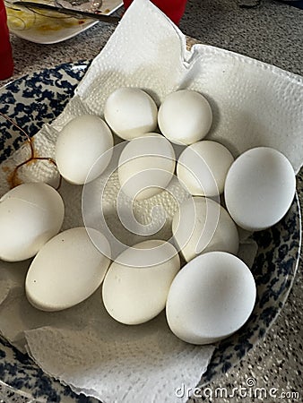 bowlful of white hardboiled eggs, ready dip in colorful bright dye. Happy Easter eggs Stock Photo